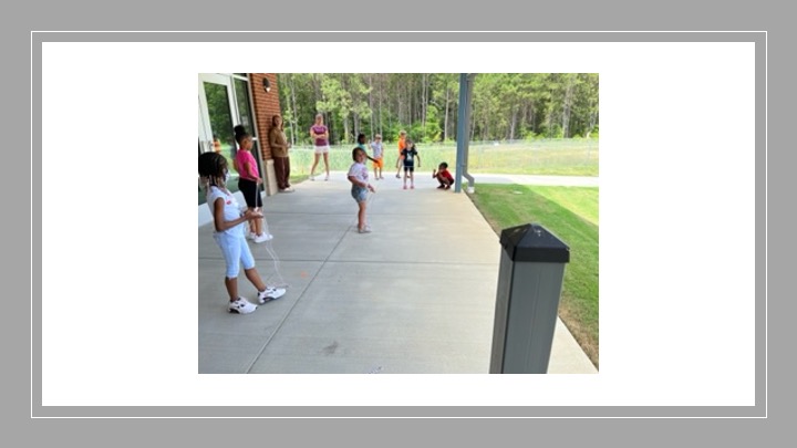 Children playing outside under an awning. 