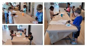 a group of children painting flower pots