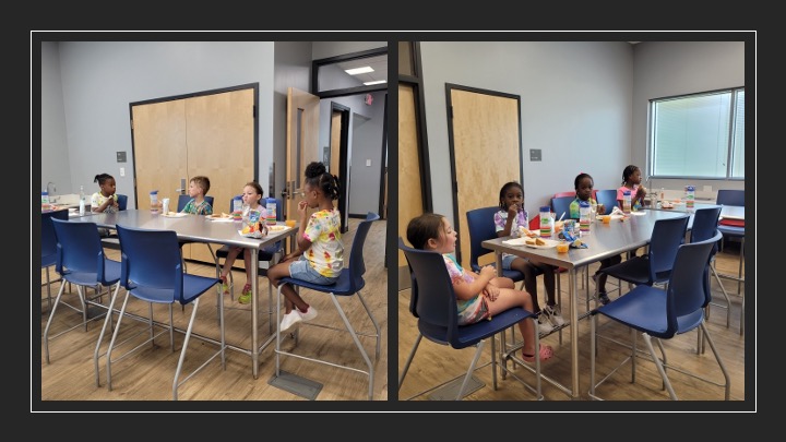Children sit together to enjoy lunch.