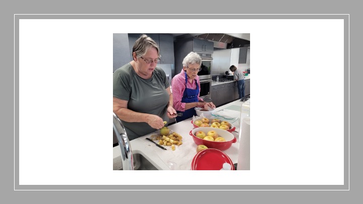 Two women process apples