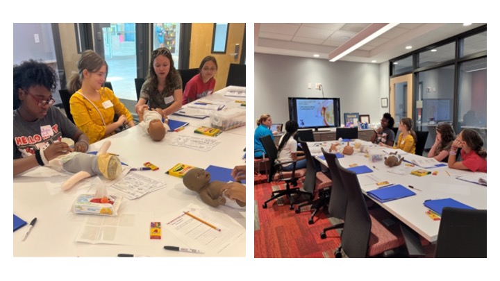 campers practicing diapering dolls and watching a presentation