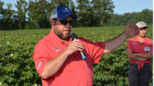 Man in Red shirt holding a microphone.