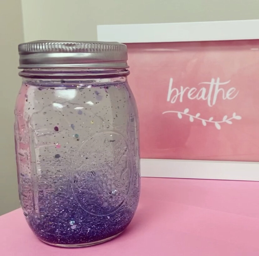 A jar of clear liquid and glitter.